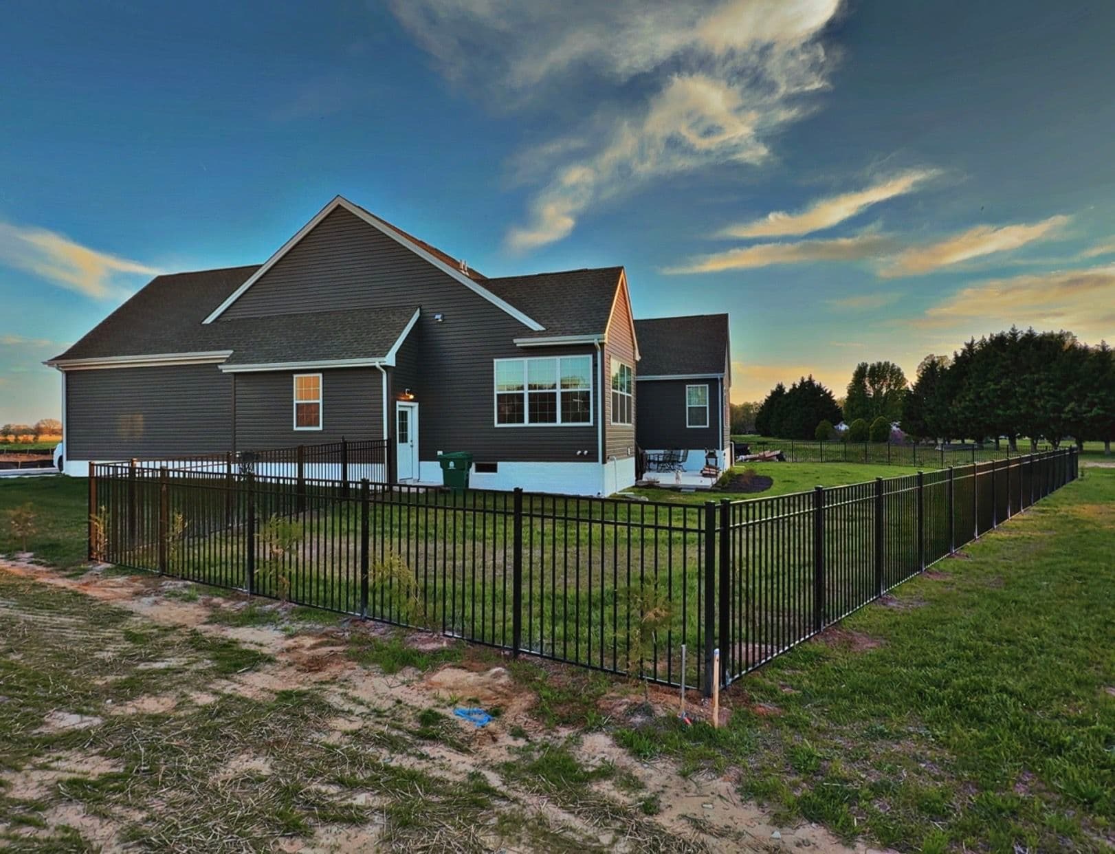Black Three-Rail Aluminum Fence Installed Around Beautiful Backyard