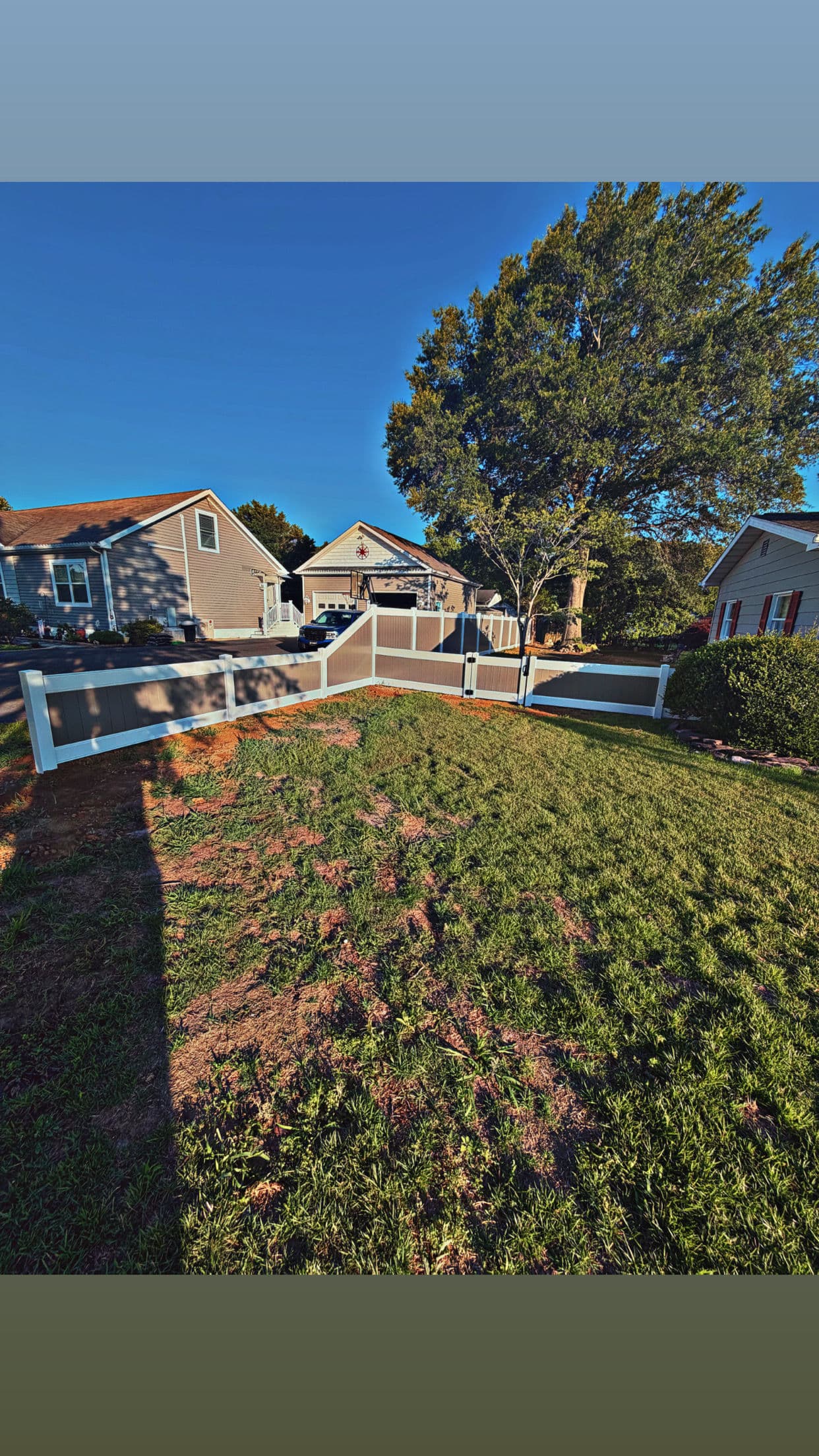 Gallery photos for Two-Tone Vinyl Fence with a Stepped Slope and Clean Gate Finish: Image #2