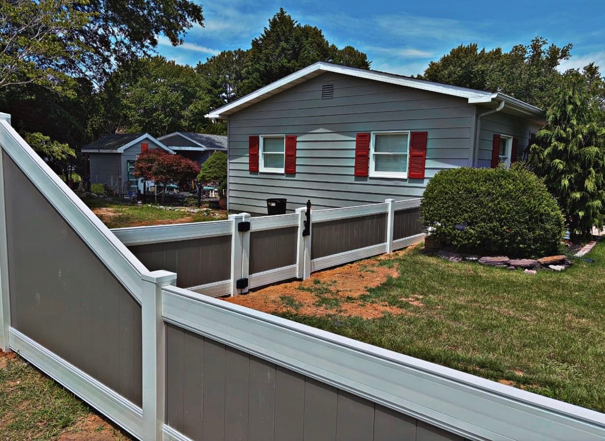 Gallery photos for Two-Tone Vinyl Fence with a Stepped Slope and Clean Gate Finish: Image #1