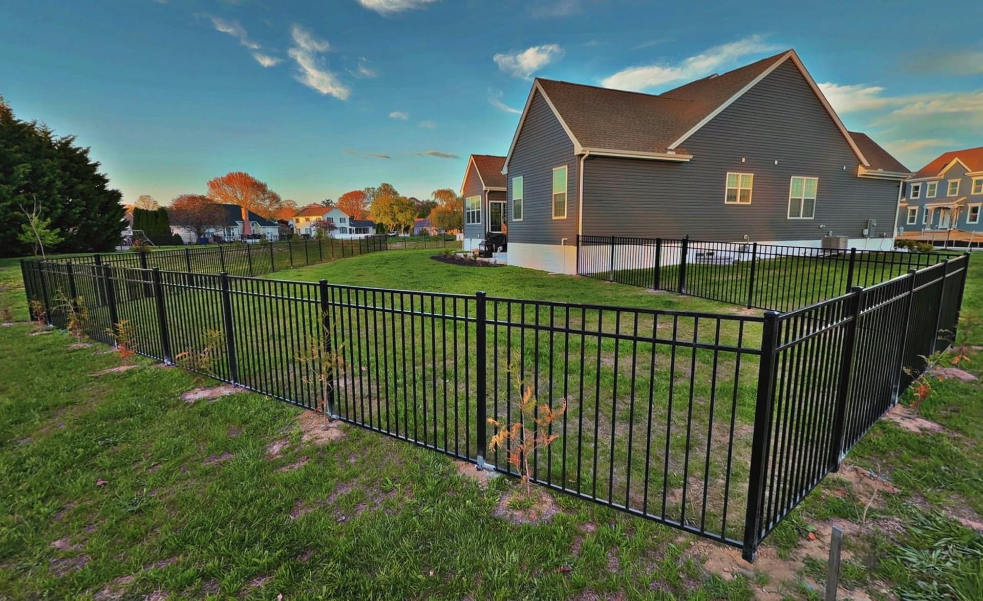 Black Three-Rail Aluminum Fence Installed Around Beautiful Backyard